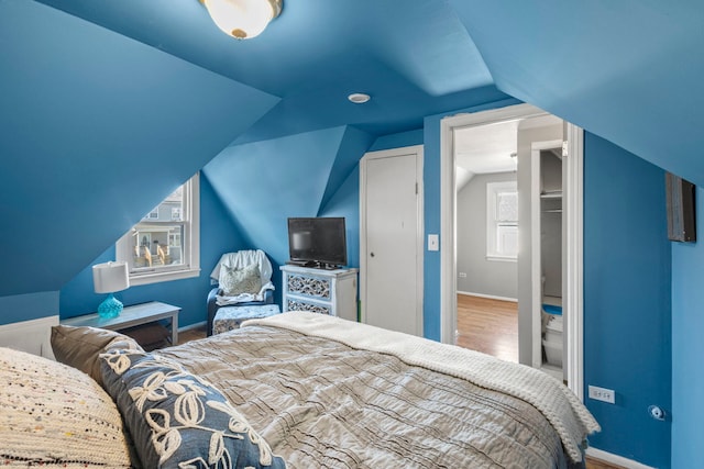 bedroom featuring vaulted ceiling, hardwood / wood-style floors, and a closet