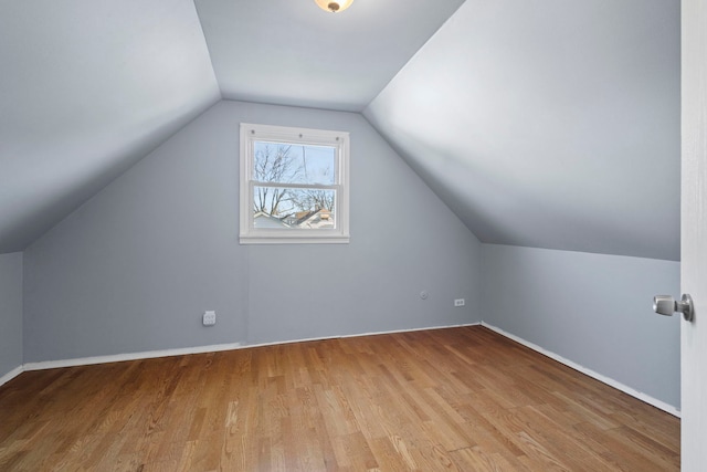 additional living space with lofted ceiling and light wood-type flooring