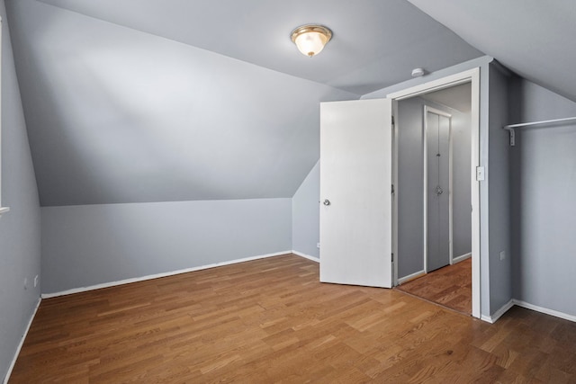 bonus room featuring lofted ceiling and hardwood / wood-style flooring