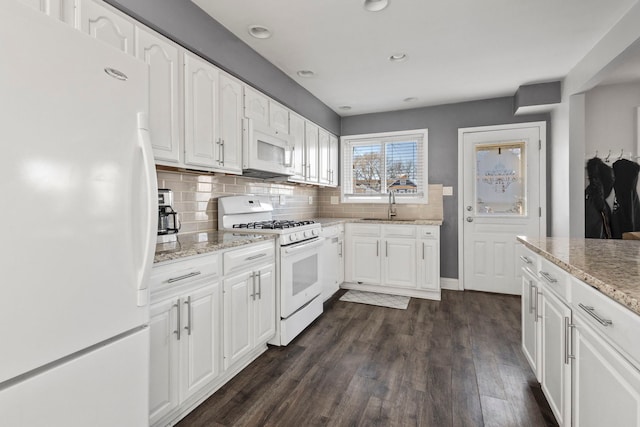 kitchen featuring white cabinetry, dark hardwood / wood-style floors, white appliances, and decorative backsplash