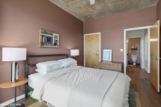 bedroom featuring connected bathroom, ceiling fan, and dark hardwood / wood-style flooring