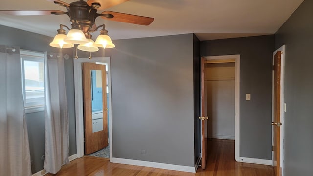 unfurnished room featuring hardwood / wood-style floors and ceiling fan