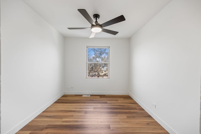 unfurnished room with ceiling fan and dark hardwood / wood-style flooring