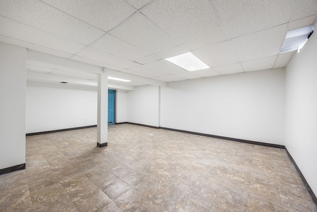 basement featuring a paneled ceiling