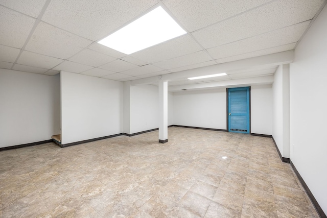 basement with a paneled ceiling