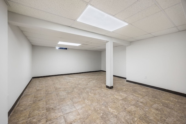 basement with a paneled ceiling