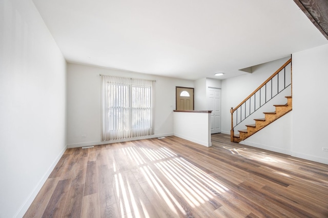 unfurnished living room with hardwood / wood-style floors