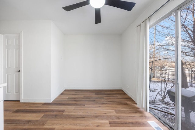 unfurnished room featuring hardwood / wood-style flooring and ceiling fan