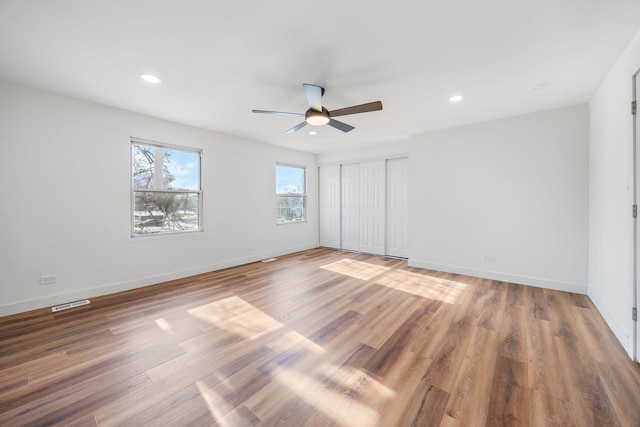 unfurnished bedroom with wood-type flooring and ceiling fan