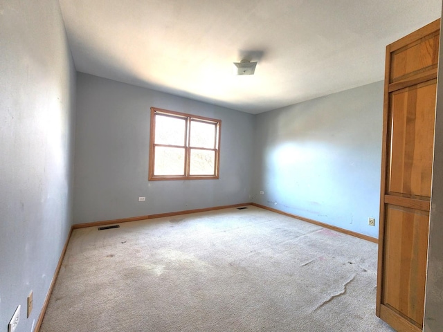 empty room featuring light carpet