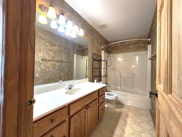 full bathroom featuring vanity, bathtub / shower combination, and toilet