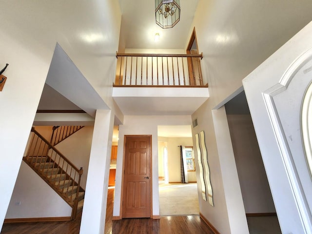 entryway with a high ceiling and dark hardwood / wood-style floors