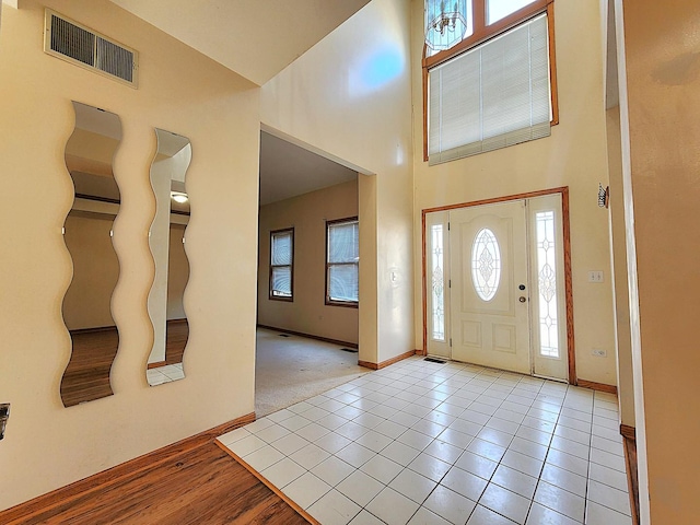 tiled foyer entrance with a high ceiling