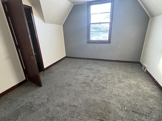 bonus room with carpet floors, baseboards, and lofted ceiling