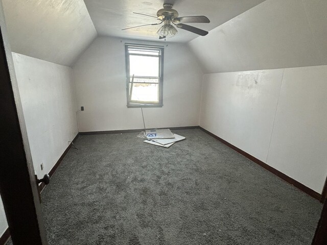 bonus room with ceiling fan, dark colored carpet, and lofted ceiling