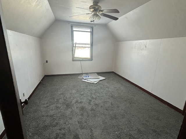 bonus room with lofted ceiling, carpet flooring, a ceiling fan, and baseboards