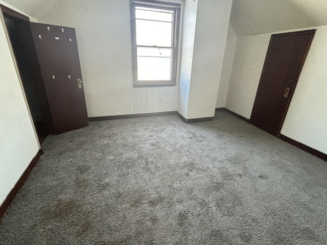 unfurnished bedroom featuring carpet flooring and baseboards