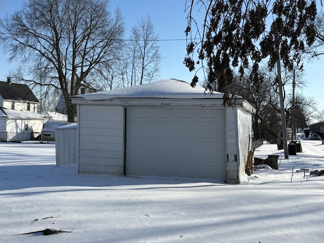 snow covered garage with a garage