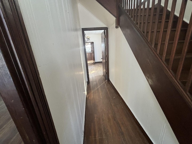 hall with dark wood-type flooring, stairway, and baseboards