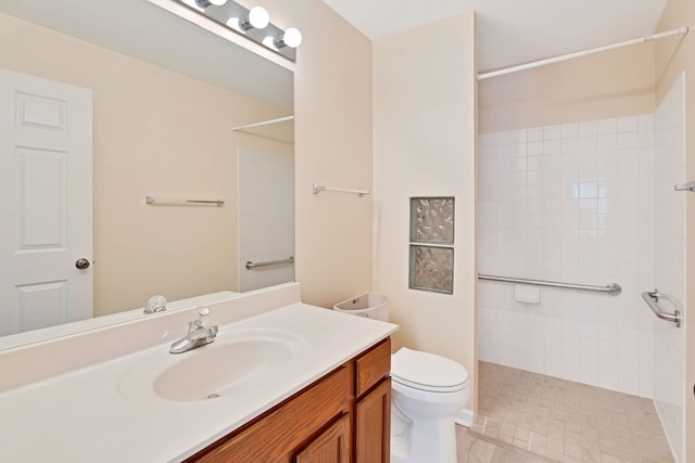 bathroom with tile patterned flooring, vanity, a shower, and toilet