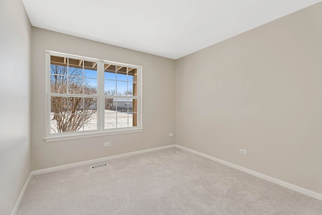 spare room with light colored carpet