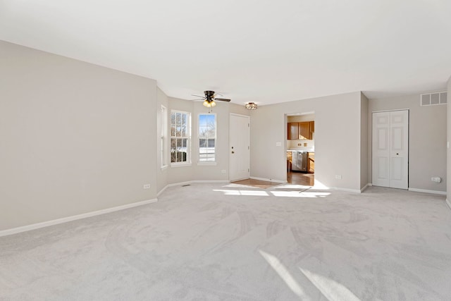 carpeted spare room with ceiling fan