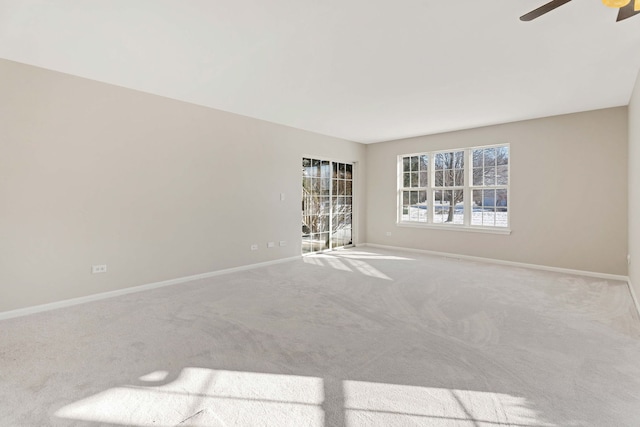 spare room with ceiling fan and light carpet