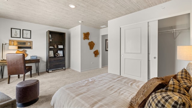 carpeted bedroom featuring a closet and wooden ceiling