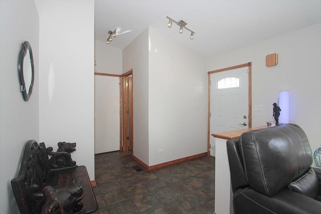 entrance foyer with lofted ceiling and rail lighting