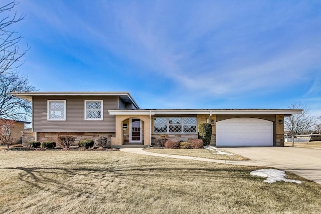 split level home with a garage and a front yard