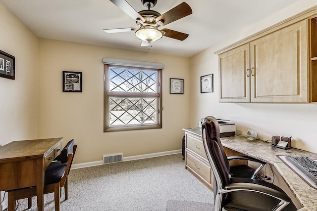 carpeted office featuring ceiling fan