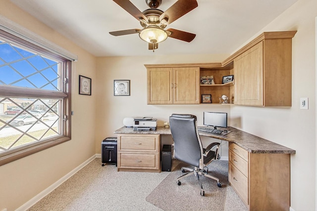 carpeted office space with ceiling fan