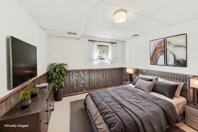 bedroom featuring a paneled ceiling and carpet flooring