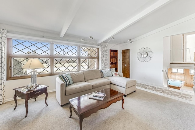 carpeted living room featuring lofted ceiling with beams