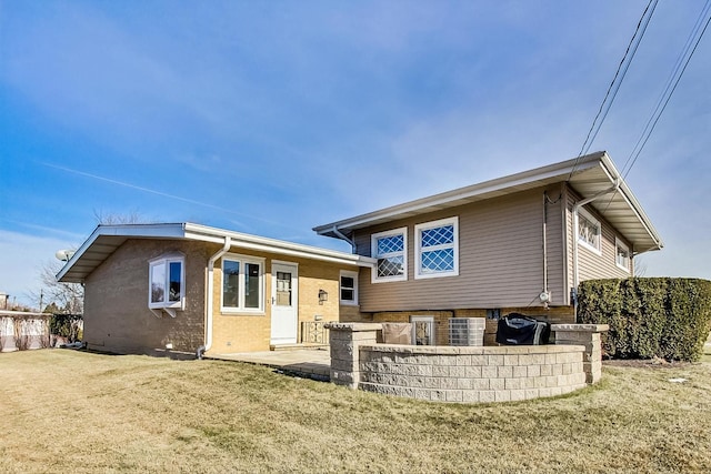 rear view of property featuring a yard