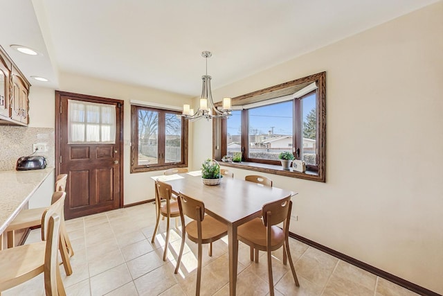 dining area with an inviting chandelier, plenty of natural light, and light tile patterned floors