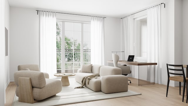 living area featuring plenty of natural light and light hardwood / wood-style flooring