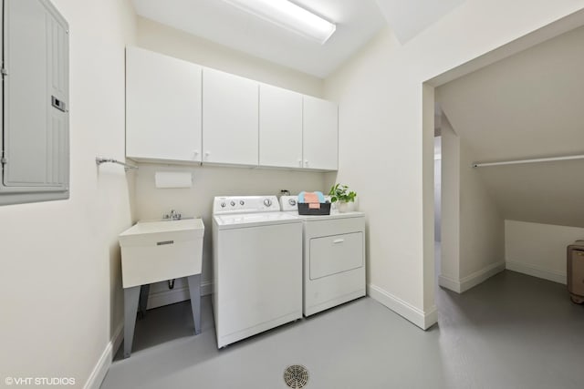 laundry area with separate washer and dryer, electric panel, and cabinets