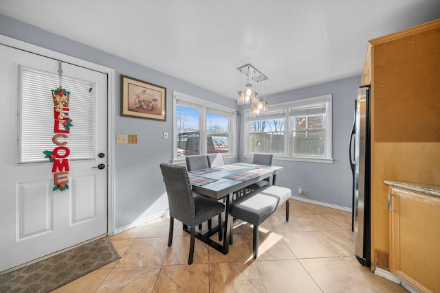 dining room featuring light tile patterned floors and a chandelier