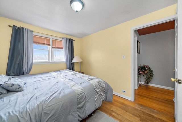 bedroom with hardwood / wood-style flooring