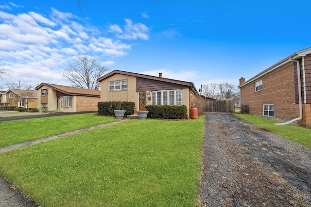 ranch-style home with a front lawn