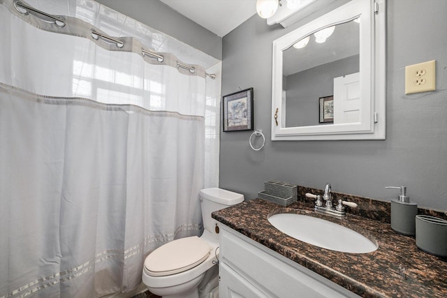 bathroom with vanity, toilet, and a shower with shower curtain