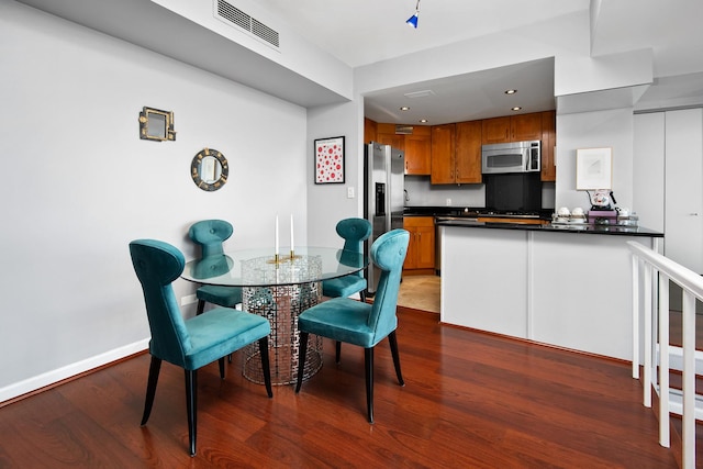 dining space with dark hardwood / wood-style flooring