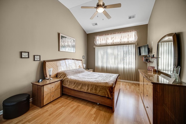 bedroom featuring light hardwood / wood-style floors, lofted ceiling, and ceiling fan