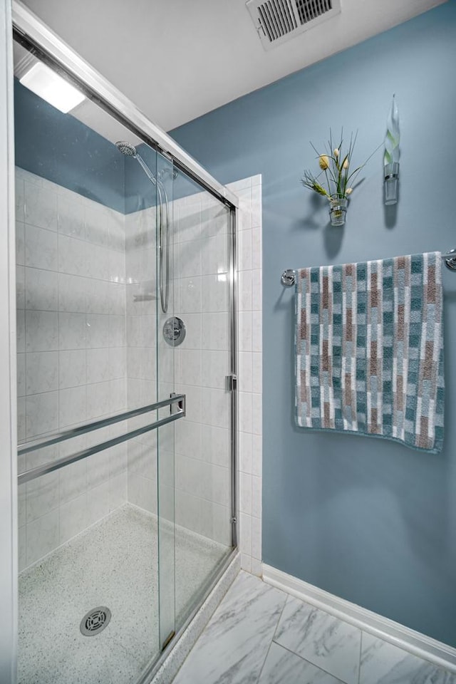 bathroom featuring a shower with shower door