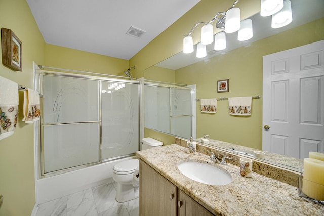 full bathroom with combined bath / shower with glass door, toilet, and vanity