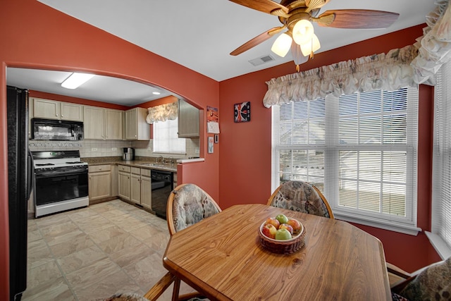 dining room featuring ceiling fan, plenty of natural light, and sink