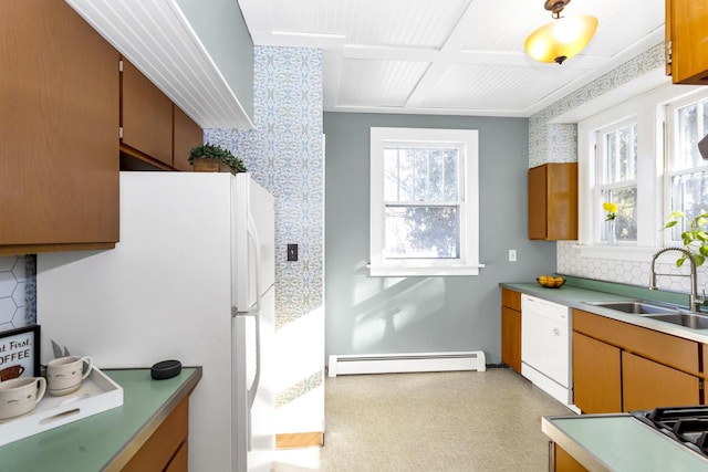 kitchen with white appliances, a baseboard radiator, and sink