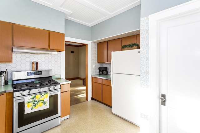 kitchen with white refrigerator, gas stove, and backsplash