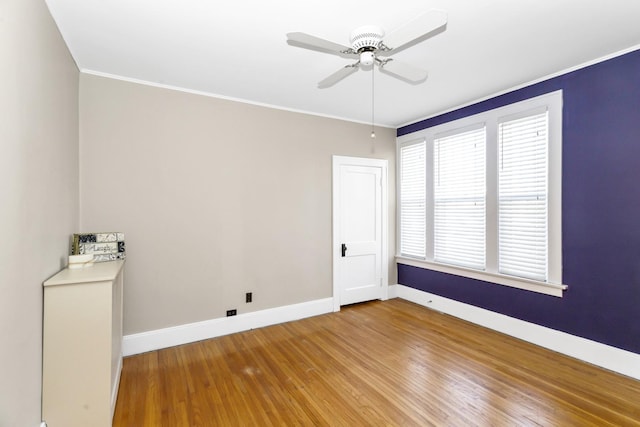 spare room with ceiling fan, a healthy amount of sunlight, and hardwood / wood-style floors